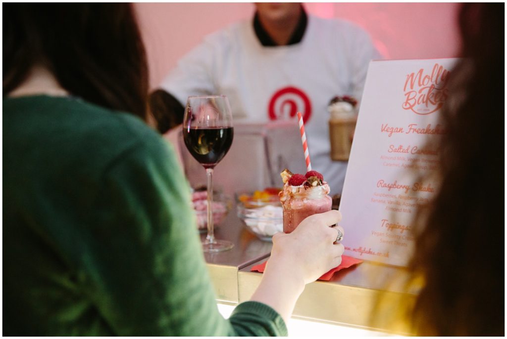 Guest holding a Molly Bakes vegan milkshake