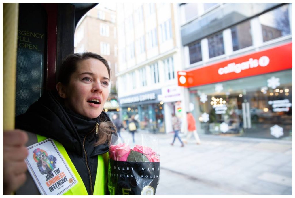 Volunteer looking onto the street from the bus