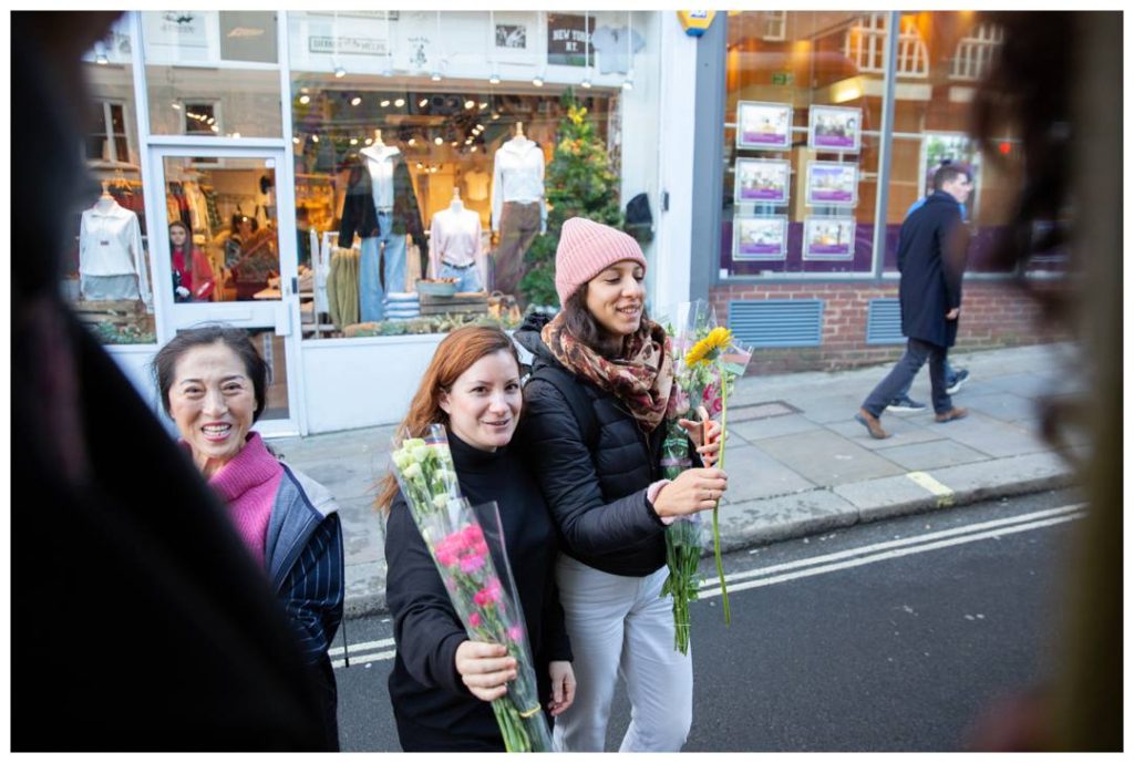 London Charity Photographer Nicola Bushnell captured Three women admiring their flowers 