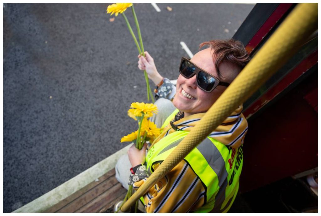 London event photos for Kindness Offensive volunteer and yellow flowers