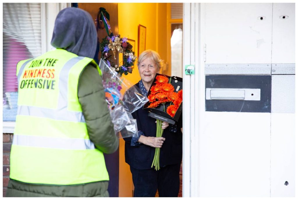 Reportage photography showing Elderly lady receiving flowers