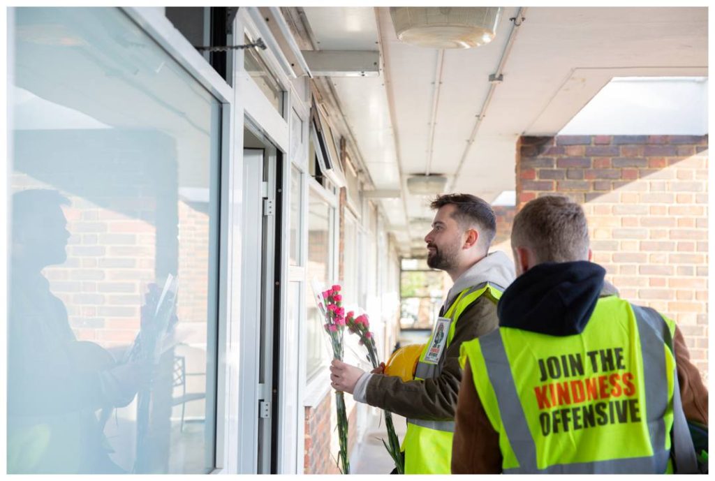 Documentary event photography with volunteers giving flowers to the elderly