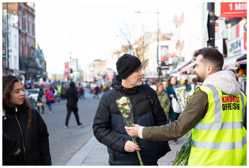 Man being given flowers in Camden
