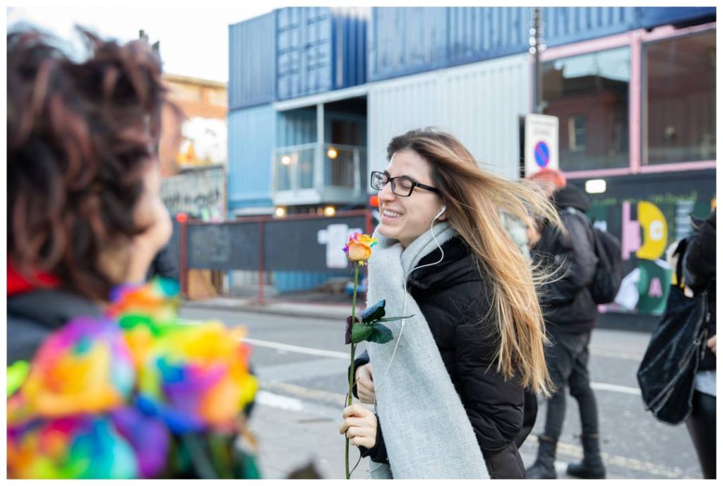 Lady happily receiving rose