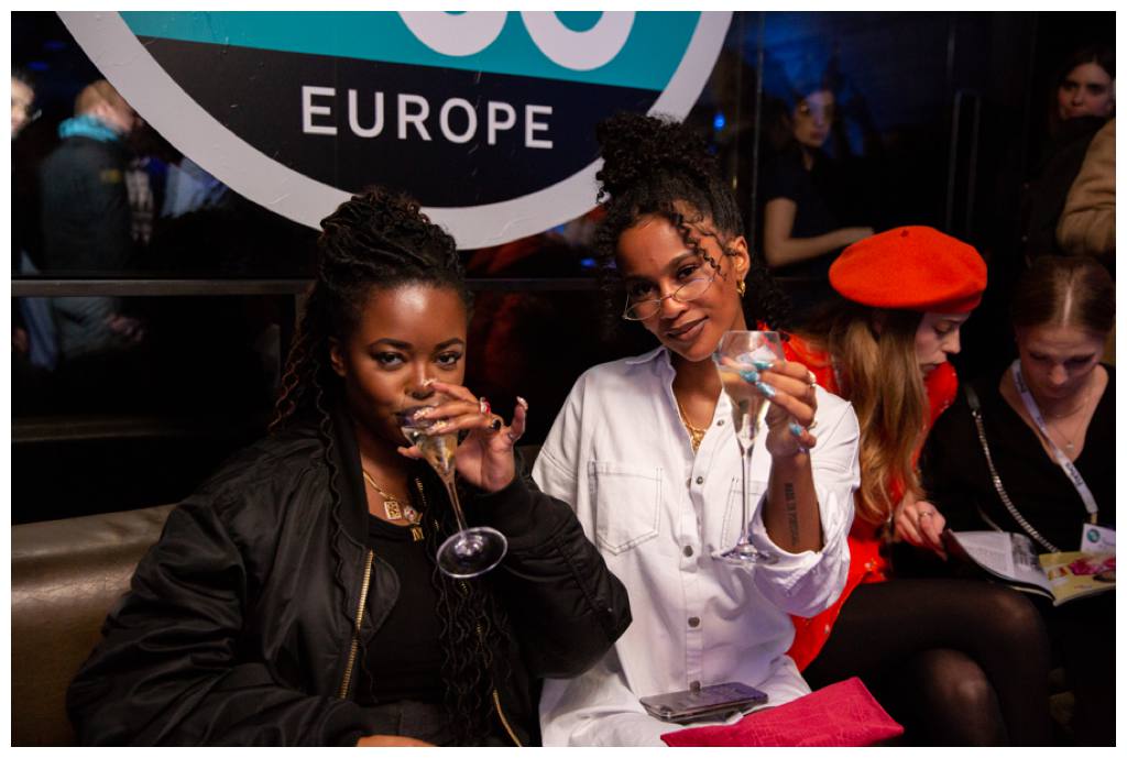 Female guests with drinks at Forbes event