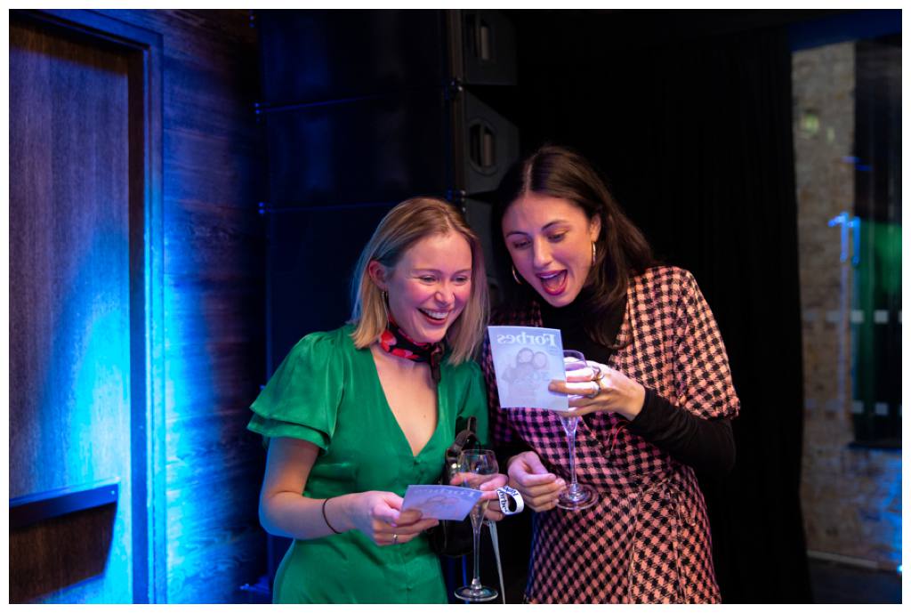 women laughing at photo at Forbes Party in London