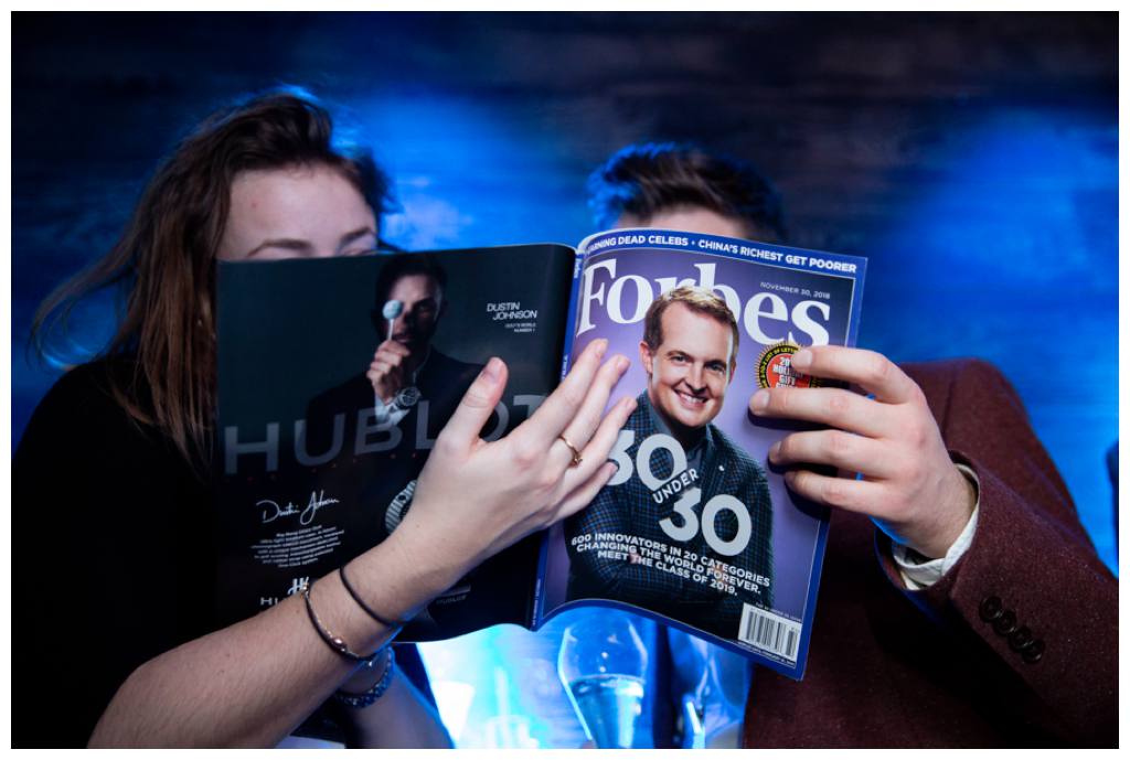 Guests looking at Forbes magazine