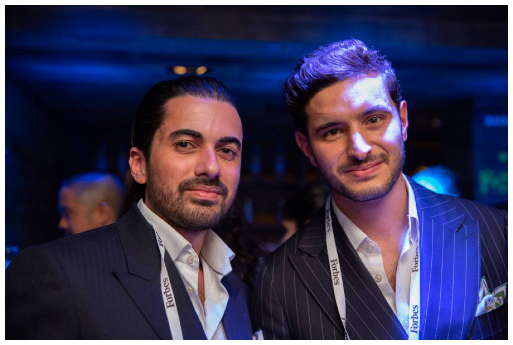 men posing at forbes corporate party in london