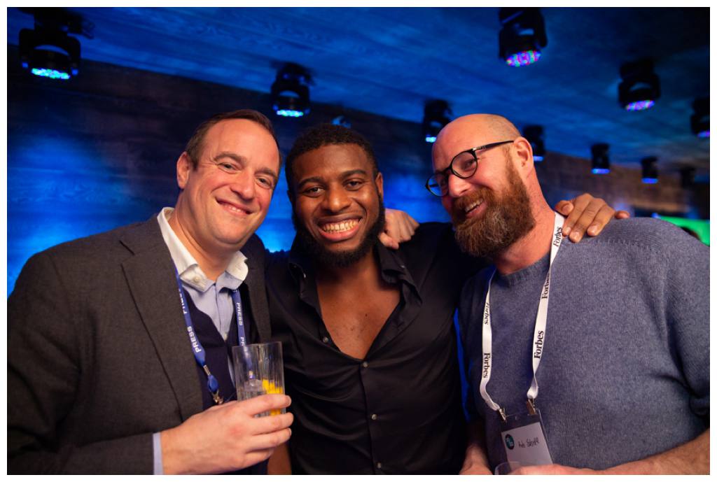 Guests posing for photo at Forbes corporate party in the London EDITION Hotel