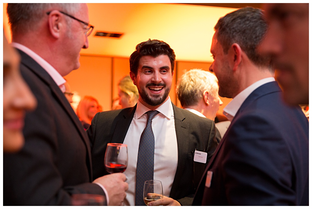 Man telling joke at Barbican corporate drinks reception photographed by London Event Photographer Nicola Bushnell