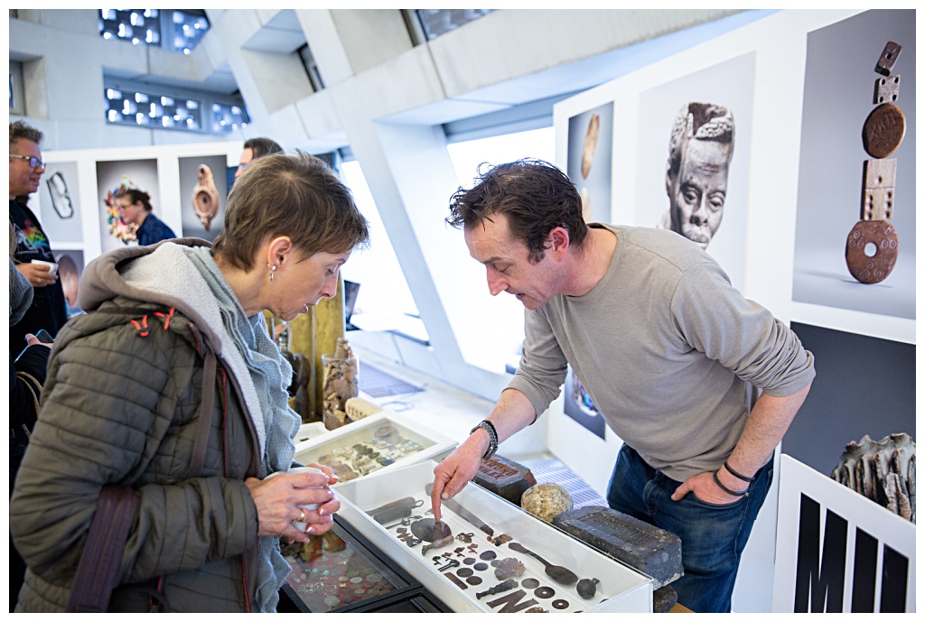 Photography at the Tate Modern with visitors looking at mudlarking finds