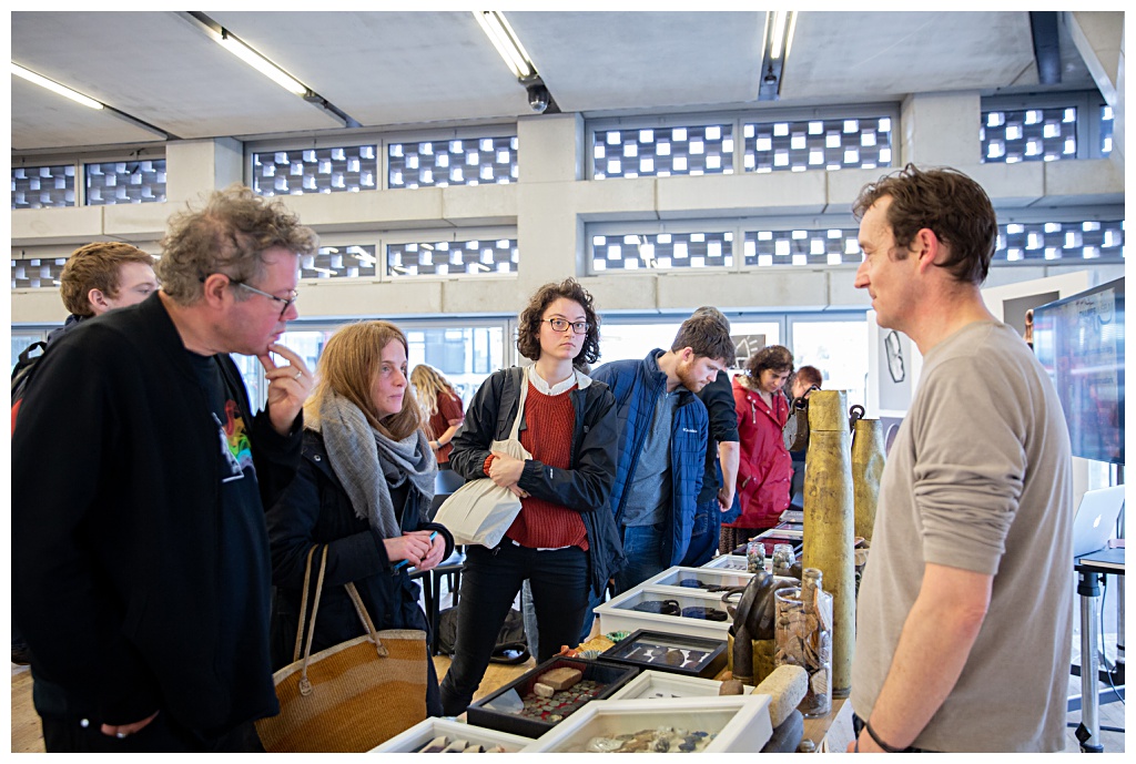 Museum visitors looking at the Tate Modern mudlarking artifacts