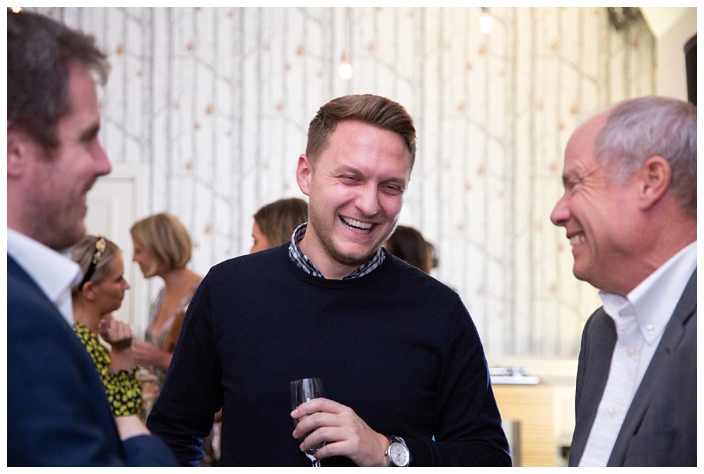 Man laughing at The House of St Barnabas party