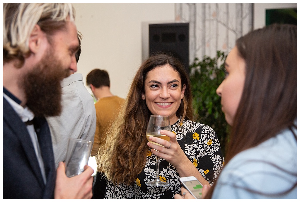 Woman with wine chatting with guests 