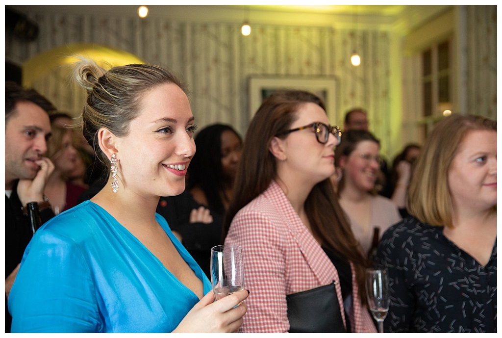 Guests enjoying a speech at The House of St Barnabas