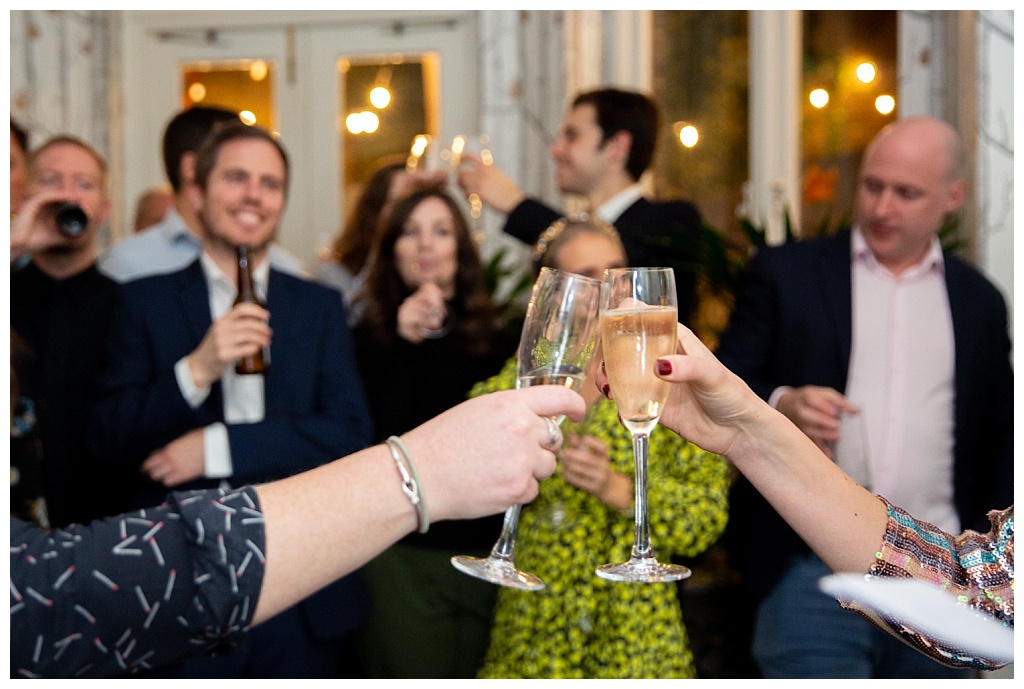 Champagne glasses touching at The House of St Barnabas