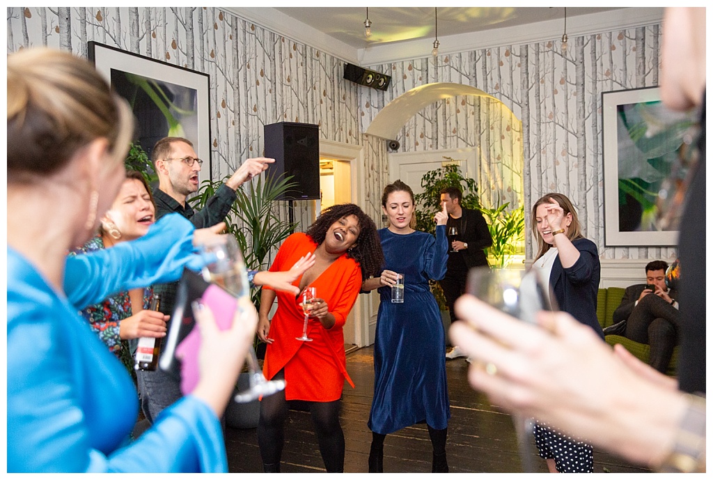 Guests singing and dancing at the party