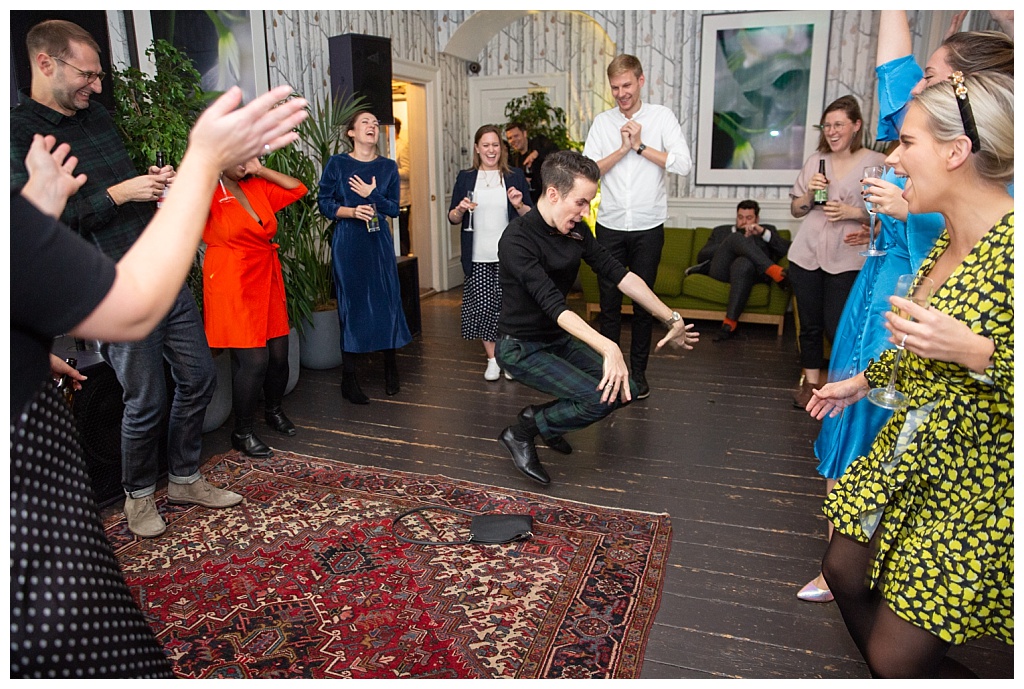 Guests cheer as man dances in the centre of the dancefloor